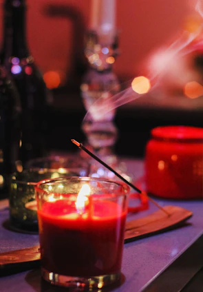 red candle on brown wooden table