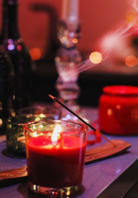 red candle on brown wooden table