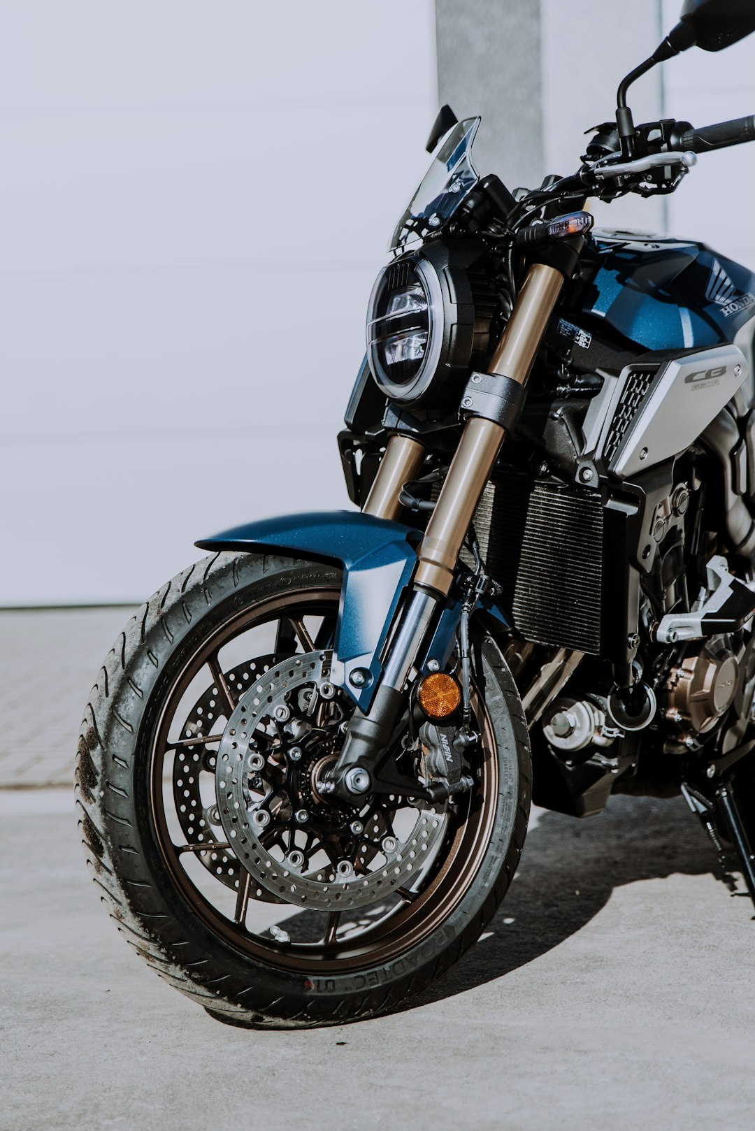 blue and black motorcycle on gray concrete floor
