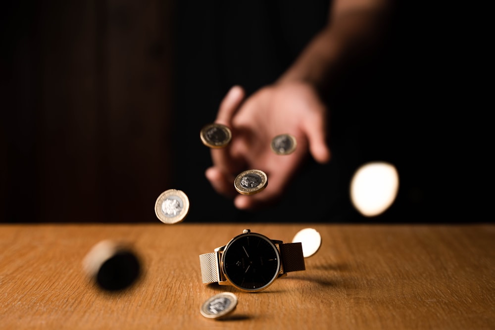 person holding silver round coins