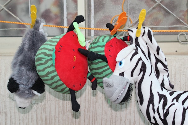 A colorful selection of animal leads hanging against a rustic wooden background