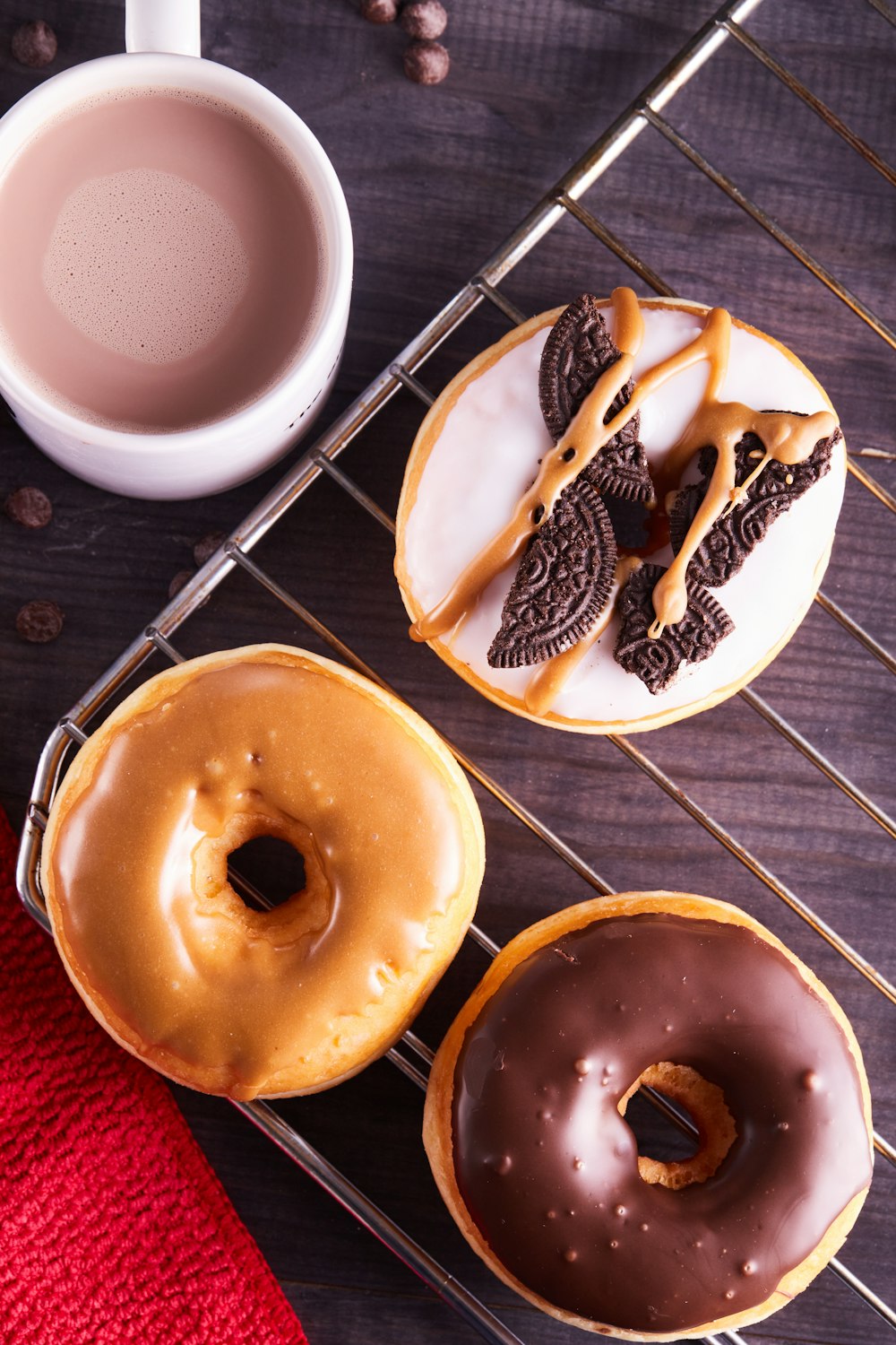 three brown donuts on white ceramic plate