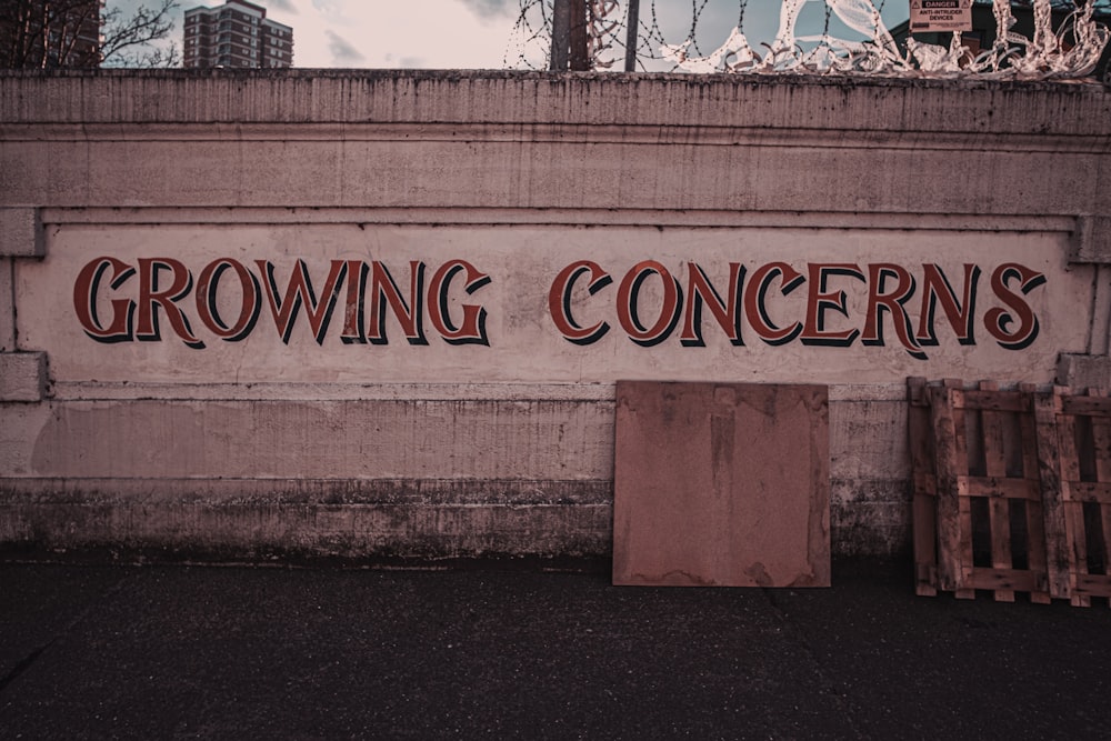 a sign on the side of a building that says growing concerns