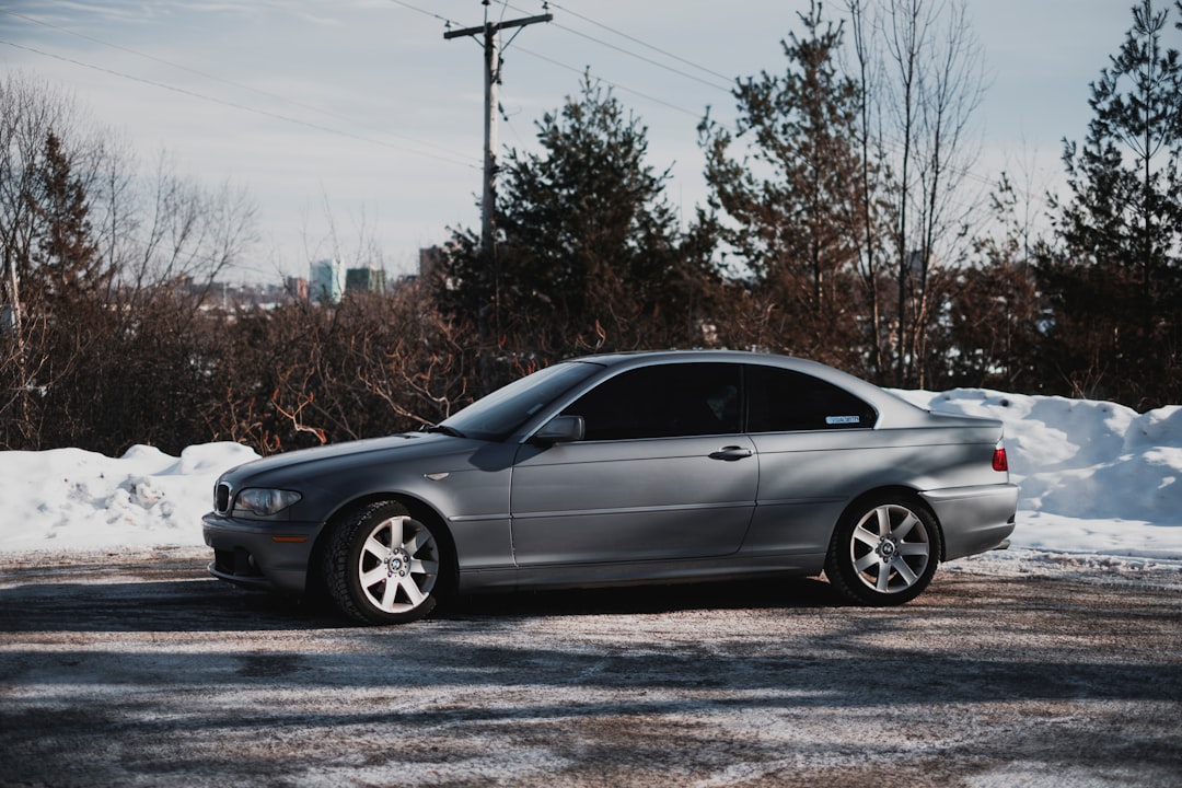 silver sedan on gray asphalt road during daytime