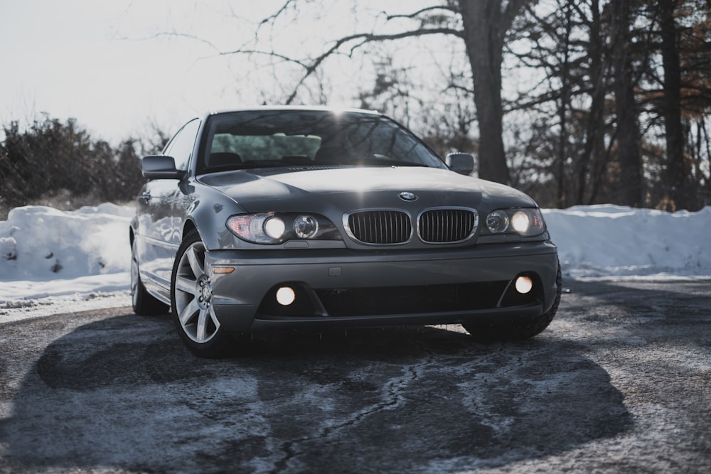 black bmw m 3 on snow covered road during daytime