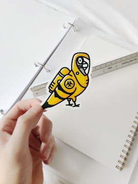 person holding yellow and black batman logo