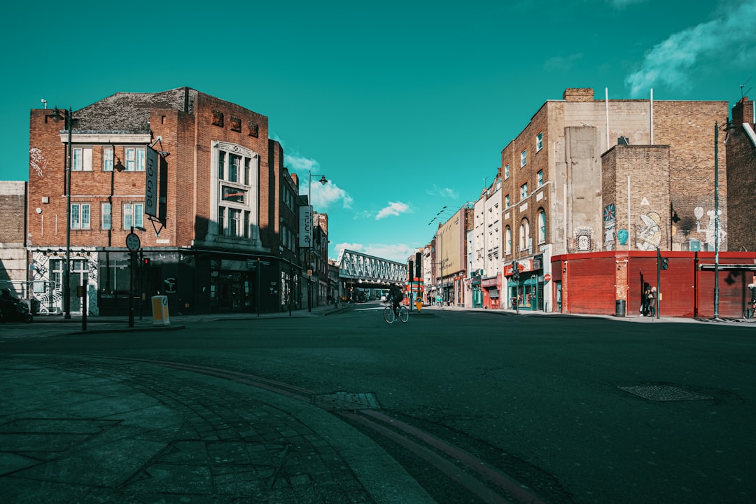 cars parked beside road near buildings during daytime