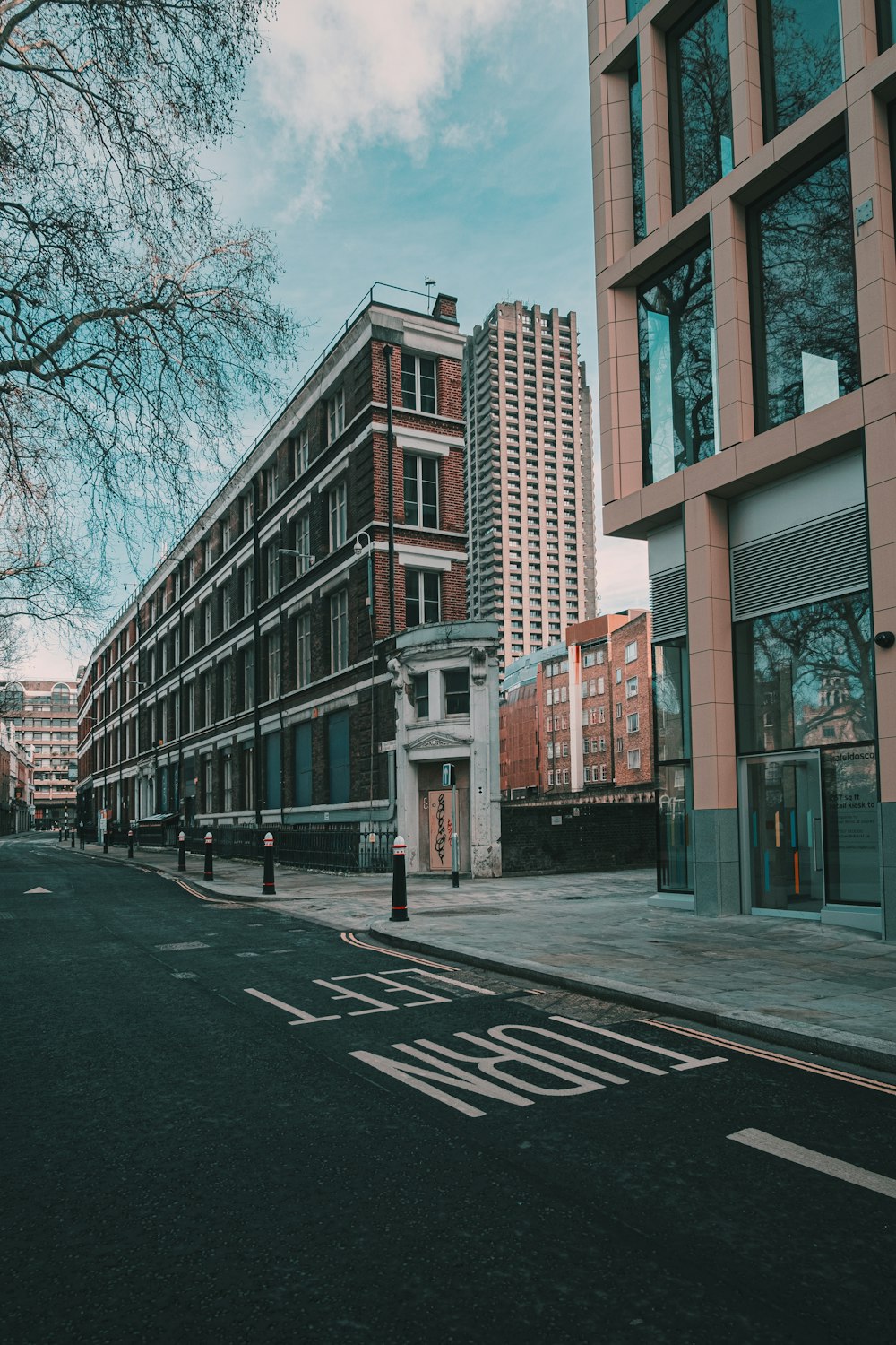 brown concrete building near bare trees during daytime