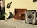 A vintage camera with the label 'Fodor-Box' sits on a rustic wooden surface next to a brown leather bag. To the left, vibrant orchids cast a dramatic shadow against a light green wall, creating a nostalgic and serene ambiance.