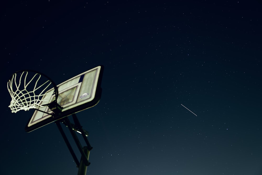 black and white basketball hoop under starry night