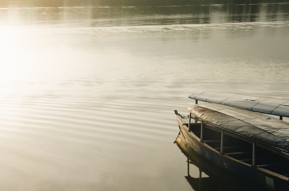 brown wooden boat on calm water during daytime