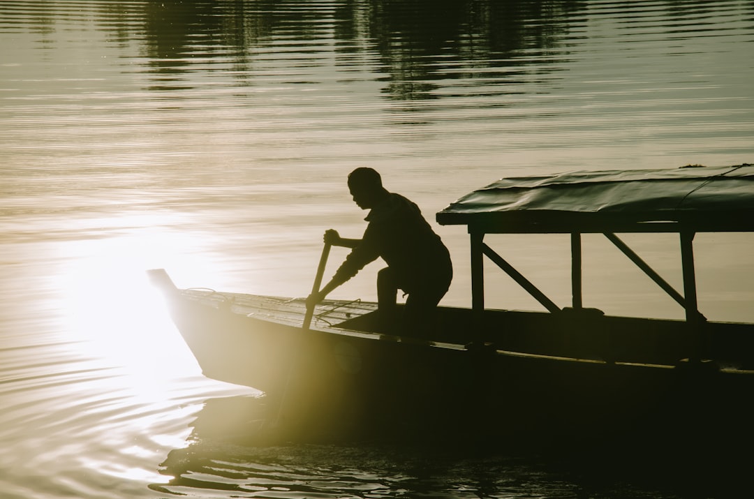 man in black shirt riding on boat during daytime