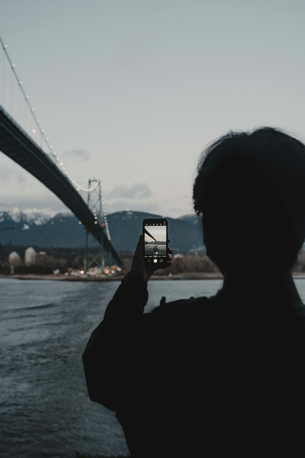 silhouette of man holding smartphone