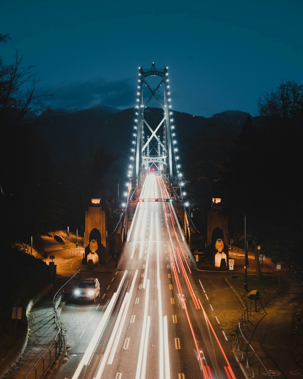 a long exposure photo of a bridge at night