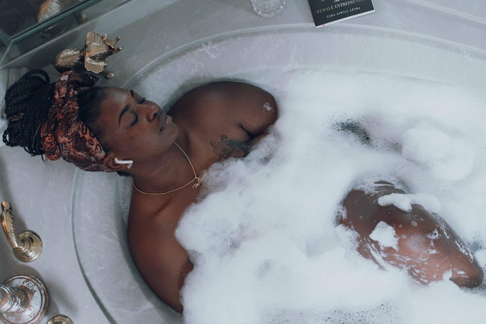 woman in white bathtub with water