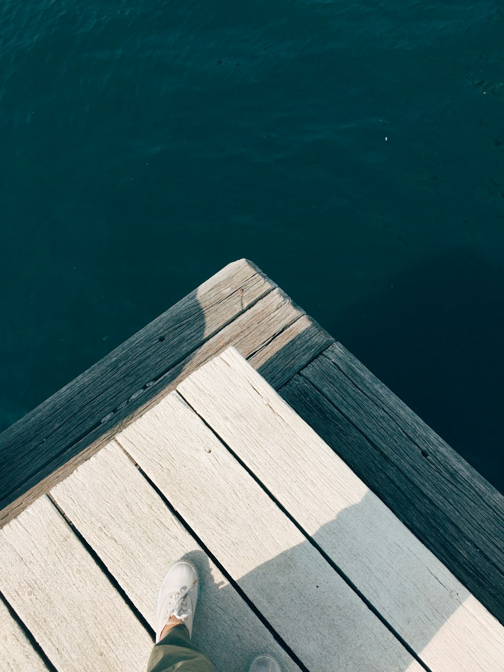 brown wooden dock on body of water