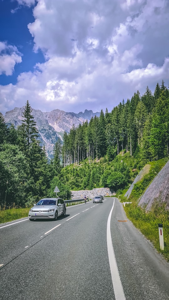 black car on road near green trees and mountain under blue sky and white clouds during in Hochkönig Austria