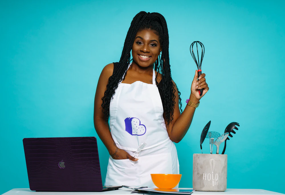 A Black woman about to eat at a café table