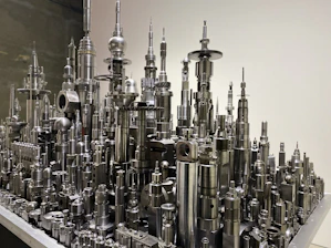 Industrial 3D printed components arranged methodically with a dark futuristic backdrop.