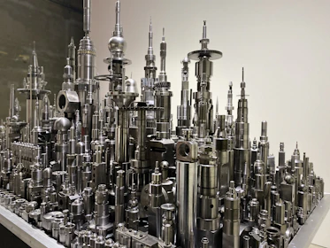 Industrial 3D printed components arranged methodically with a dark futuristic backdrop.