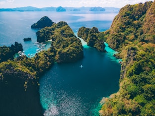 brown rock formation on blue sea during daytime