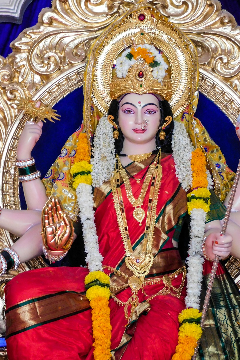 woman in red and gold sari dress