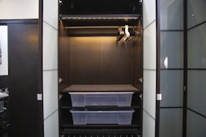 Modern built-in wardrobe with sliding doors and organized shelves in a bedroom