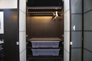 A modern wardrobe with sliding doors and integrated lighting.