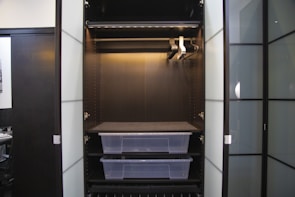 A spacious modular wardrobe featuring sliding doors and organized storage solutions.