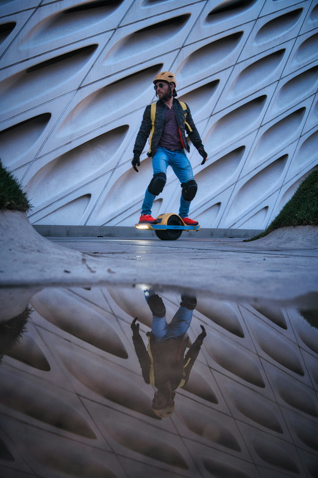 woman in black jacket and blue denim jeans sitting on white concrete stairs