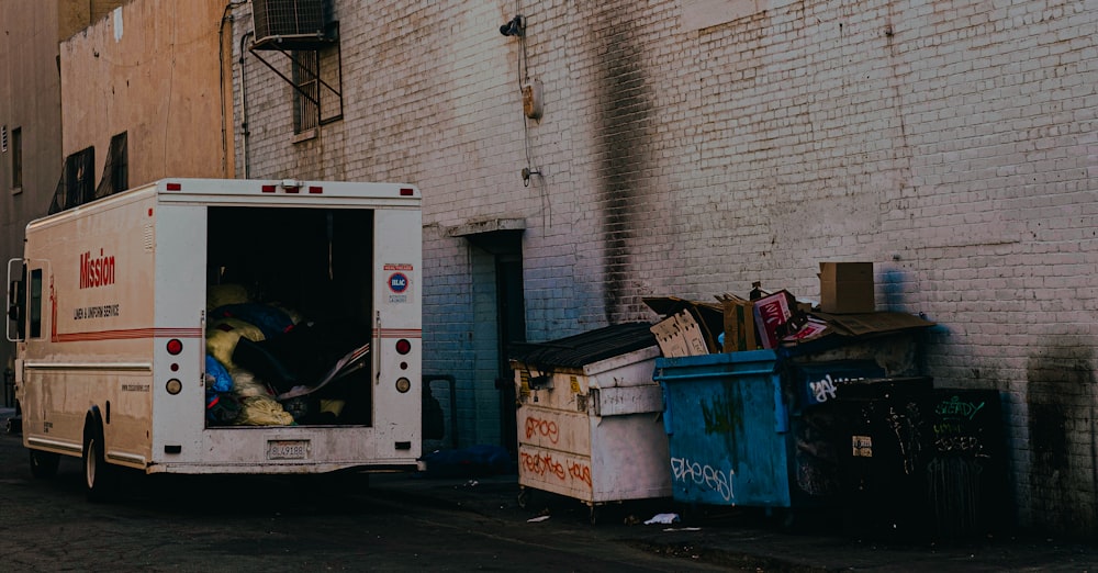 white van parked beside gray concrete wall