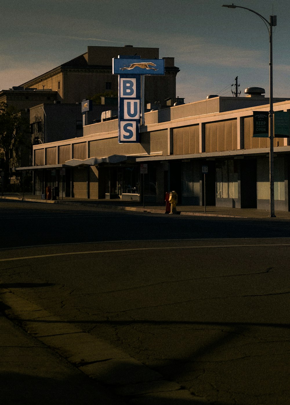 a blue bus sign sitting on the side of a road