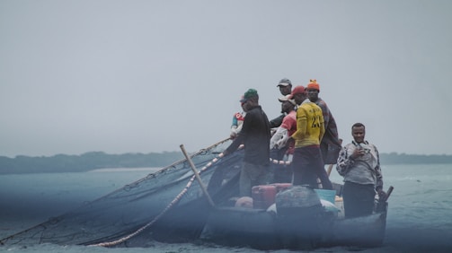 Fishermen working together on a small boat.