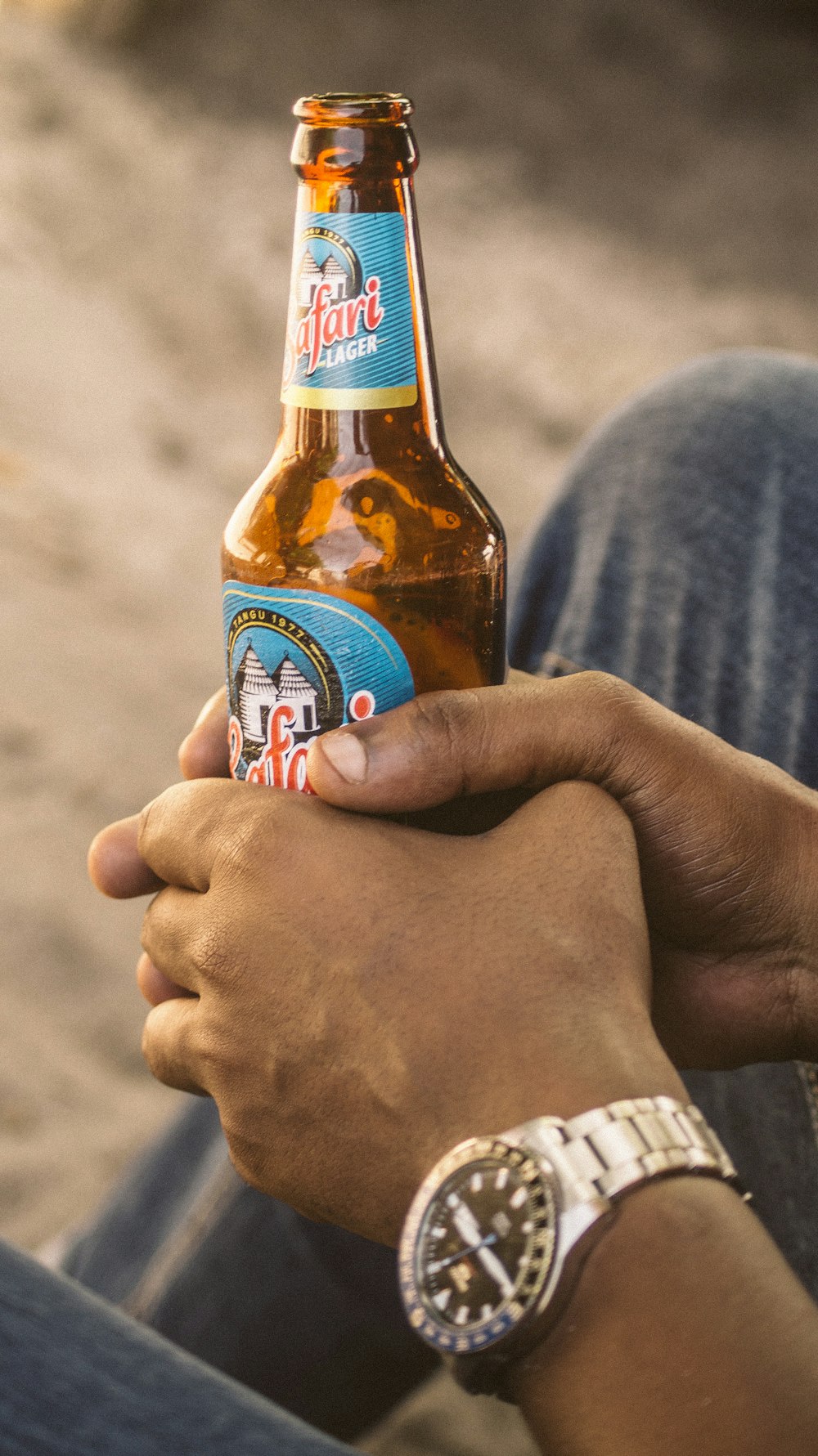 person holding a blue moon bottle