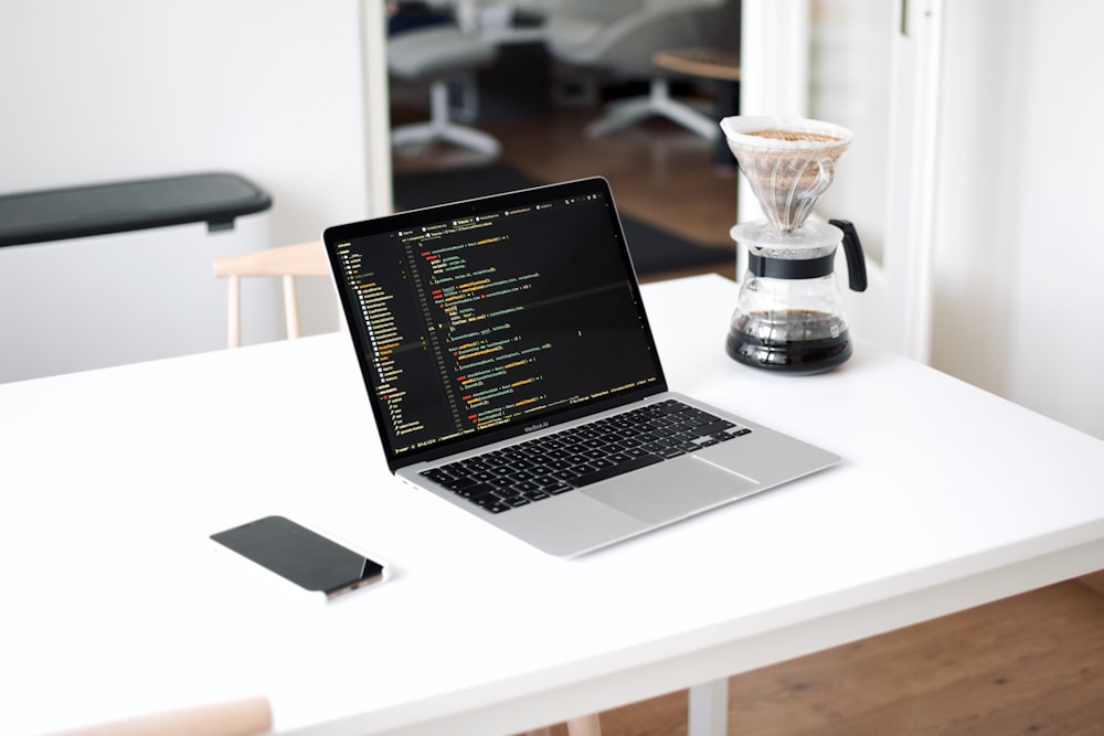 macbook pro on white table