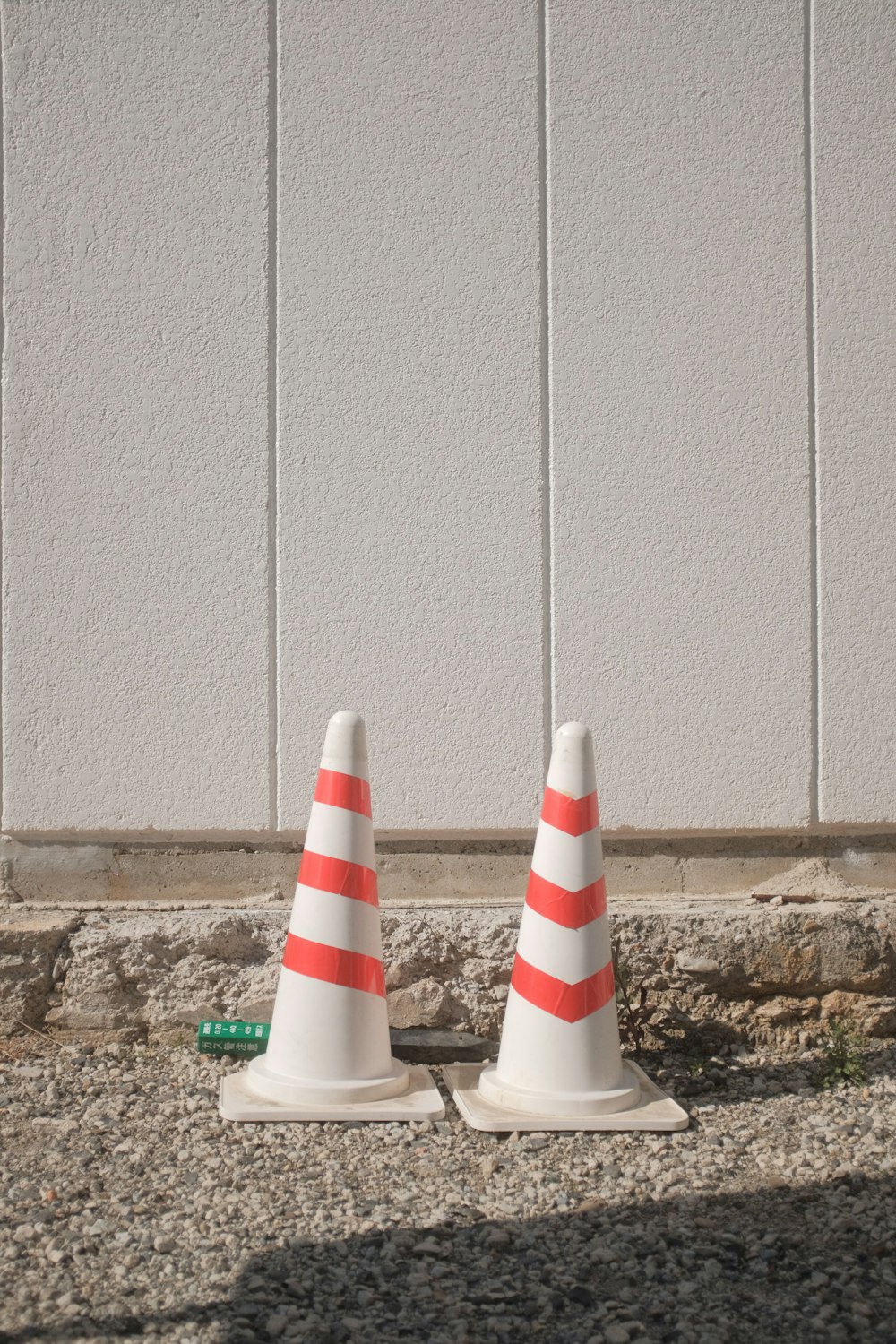 white and red striped traffic cone