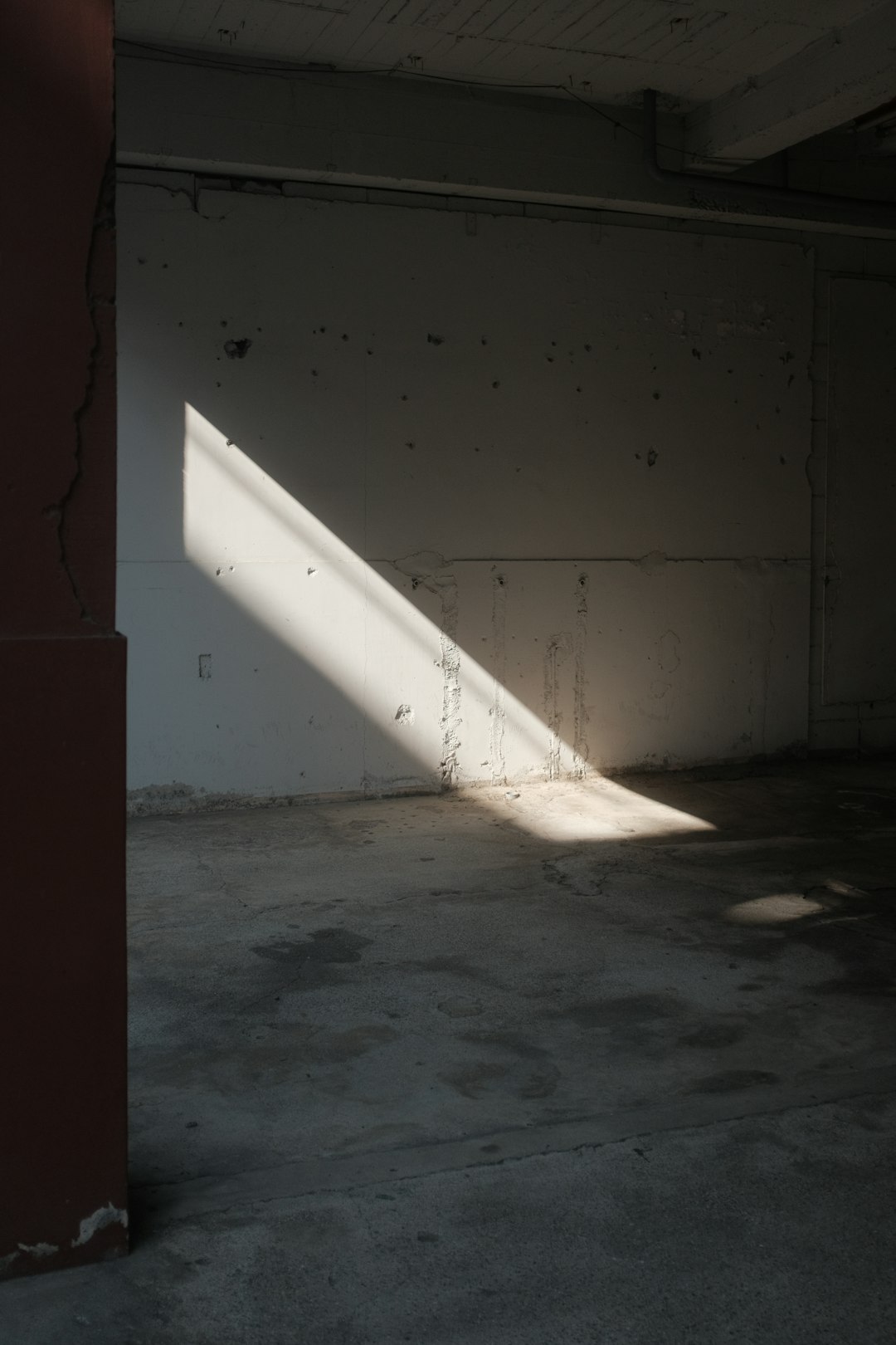 white concrete wall near body of water during daytime