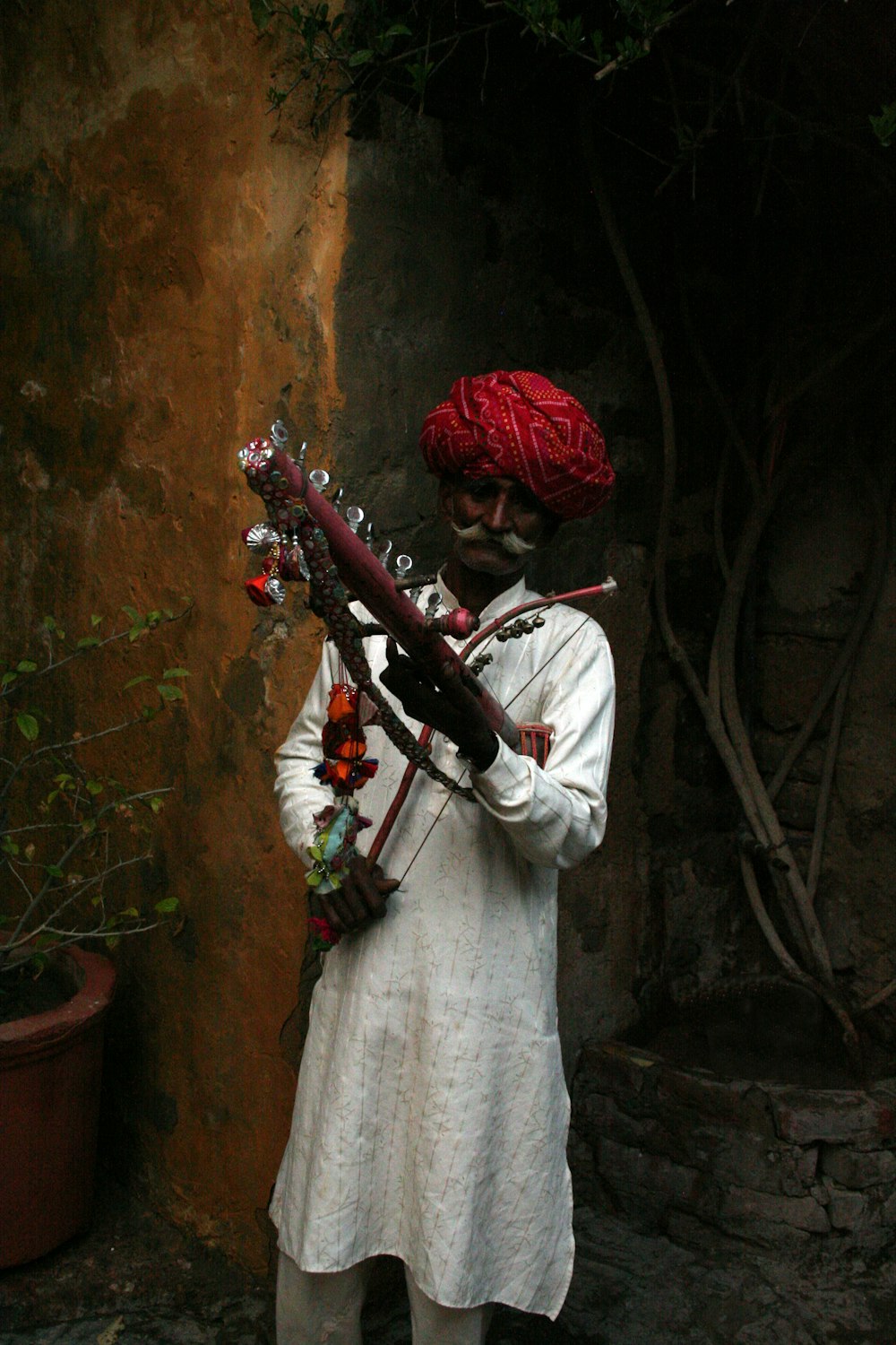 man in white long sleeve shirt playing violin