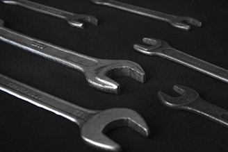 stainless steel wrench on black surface