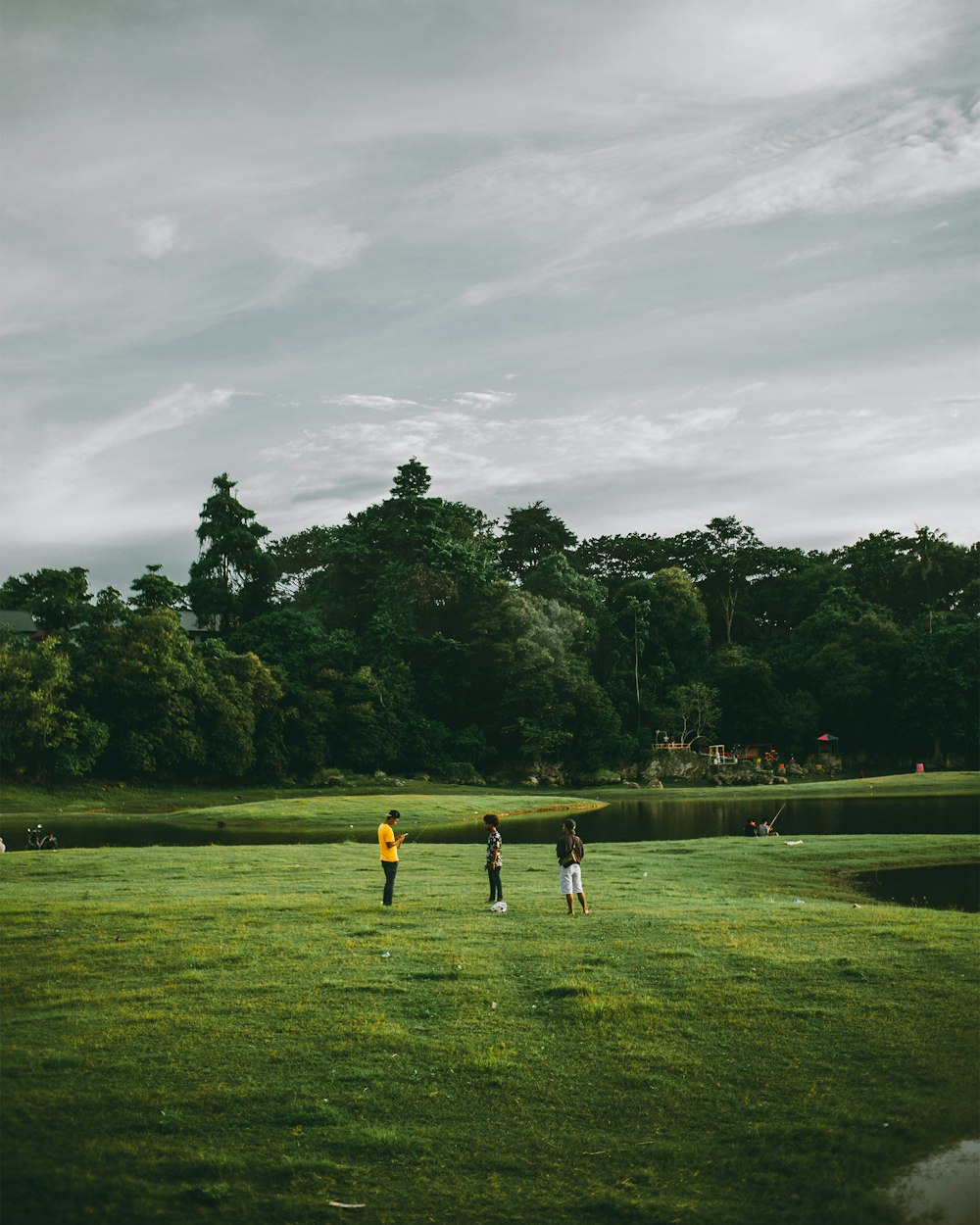 people playing soccer on green grass field during daytime