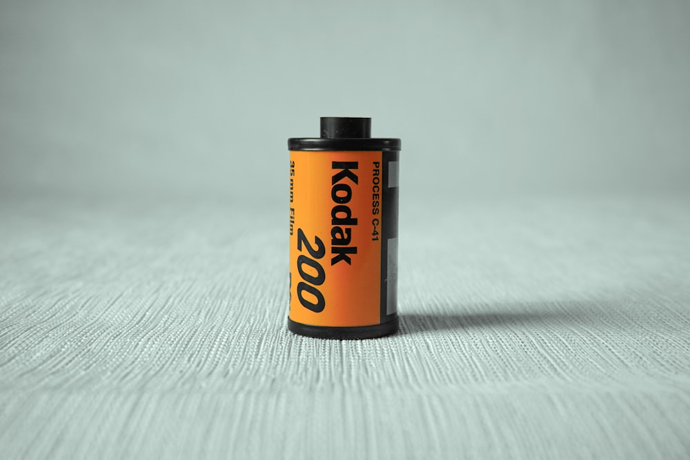 a can of kodak on a white surface
