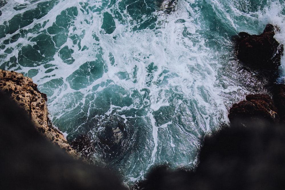 water waves on brown rock