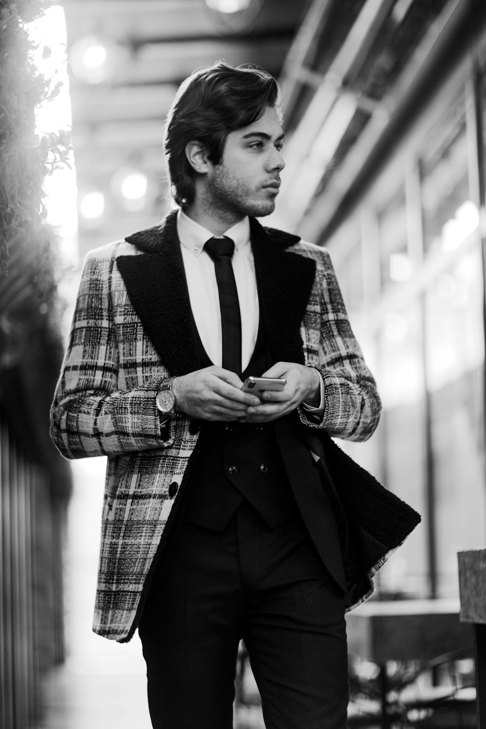 man in black and white plaid coat