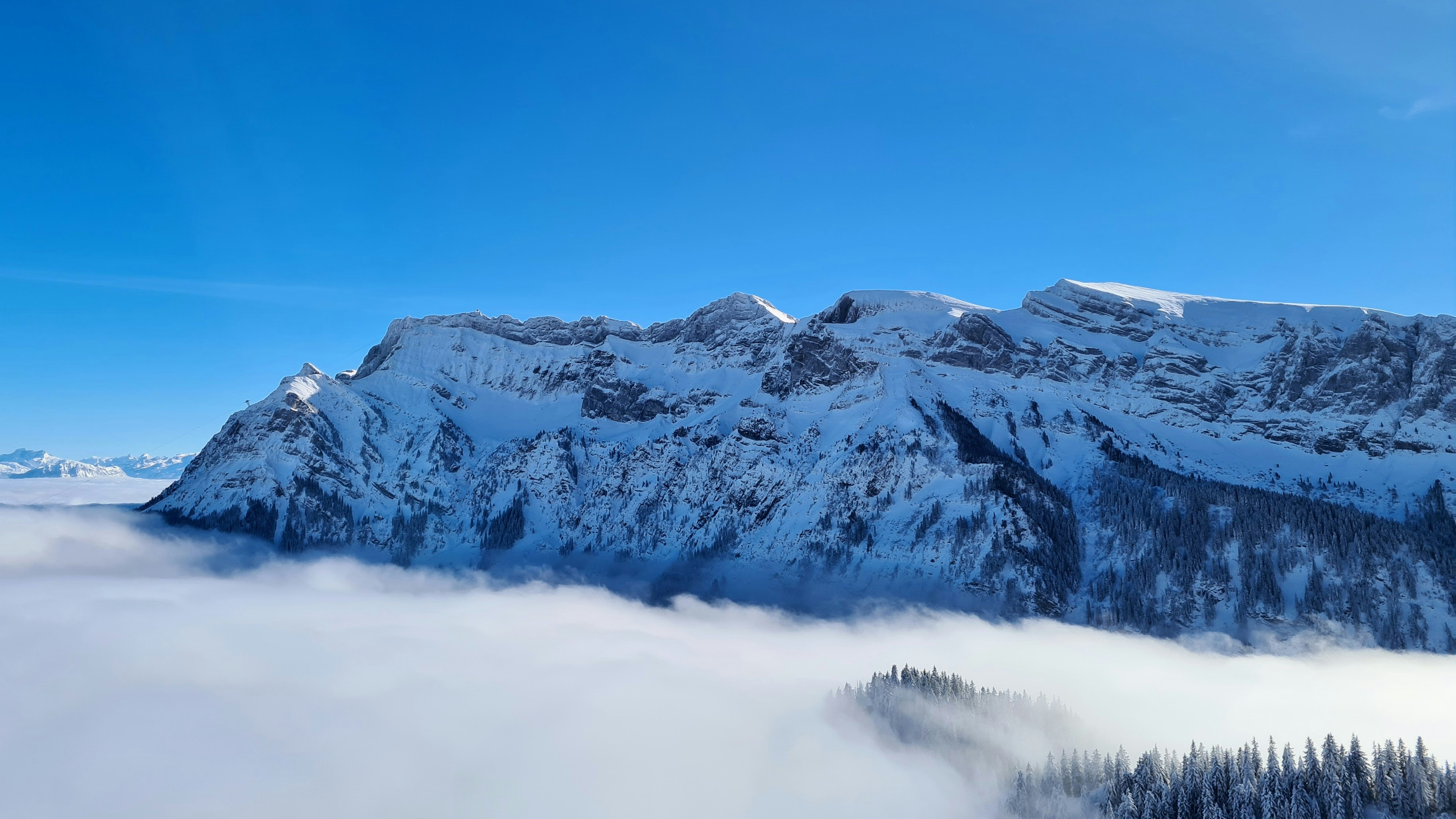 snow covered mountain under blue sky during daytime