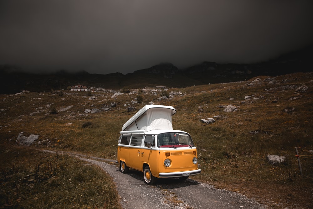 yellow and white volkswagen t-2 on brown field during daytime