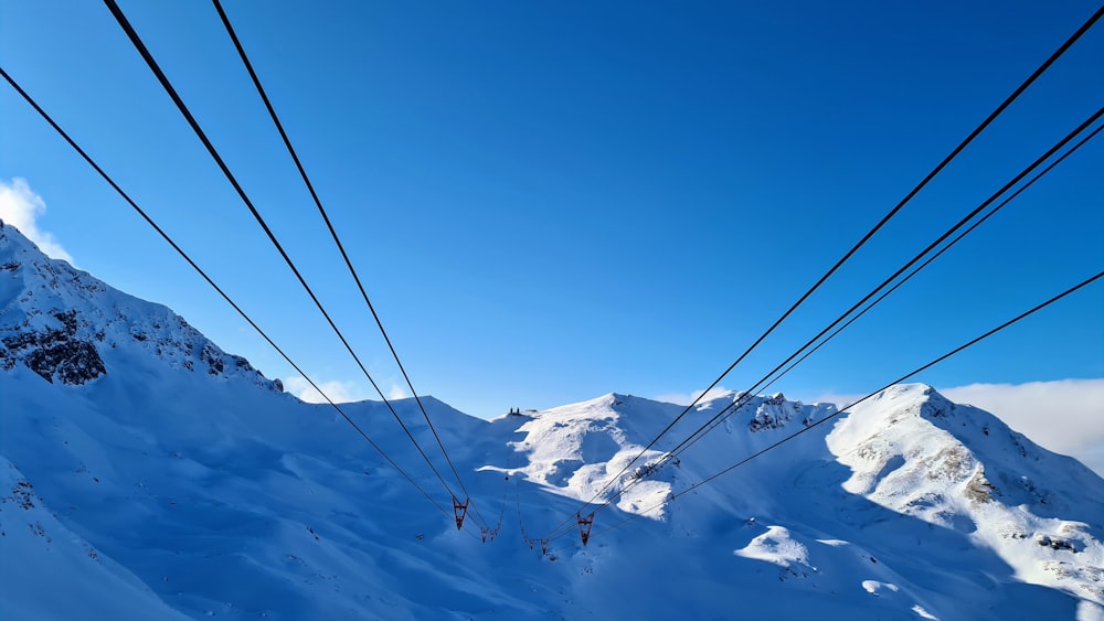 black cable cars over snow covered mountain during daytime