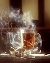 clear glass mug with brown liquid