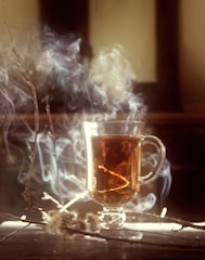 clear glass mug with brown liquid