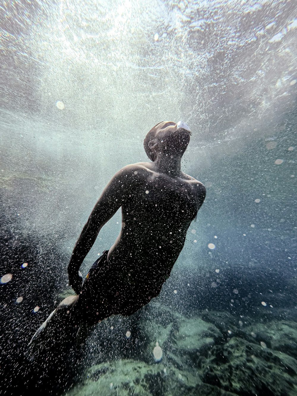 man in water with blue and white lights