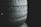 Several stacked tires with visible tread patterns create a textured and industrial look. The background is dark, emphasizing the contrast and details of the rubber surfaces.